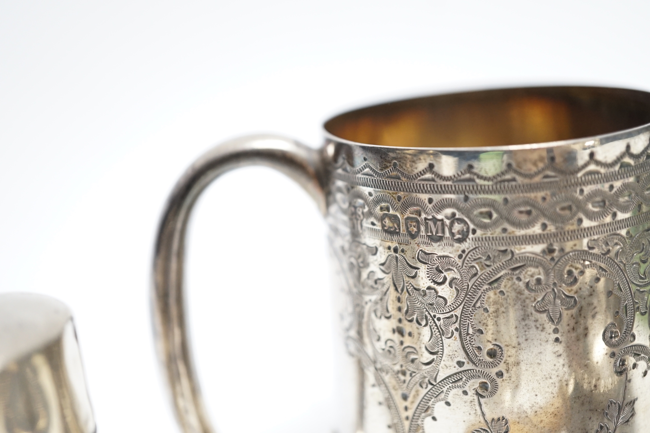 A Victorian engraved silver christening mug, Charles Stuart Harris, London, 1887, 71mm and other items including silver scent bottle, napkin rings and tea strainer.